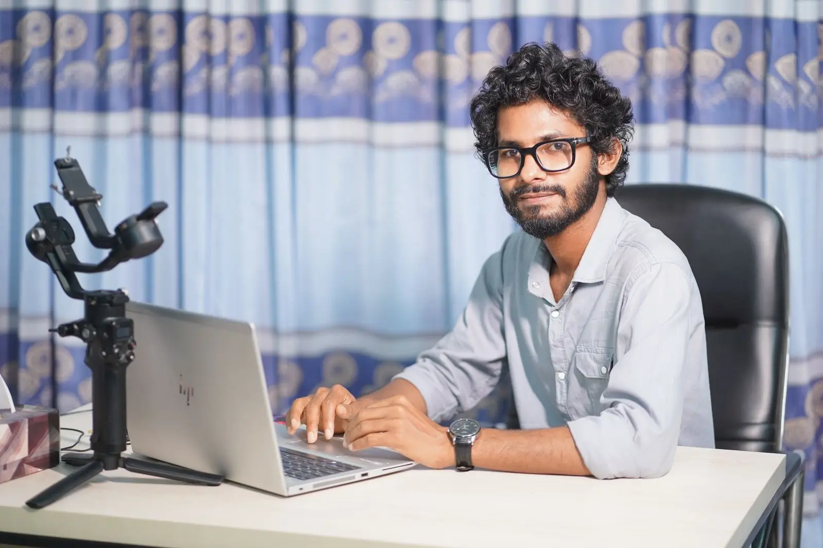Office desk-এ laptop ব্যবহার করে website form security review করছেন একজন developer